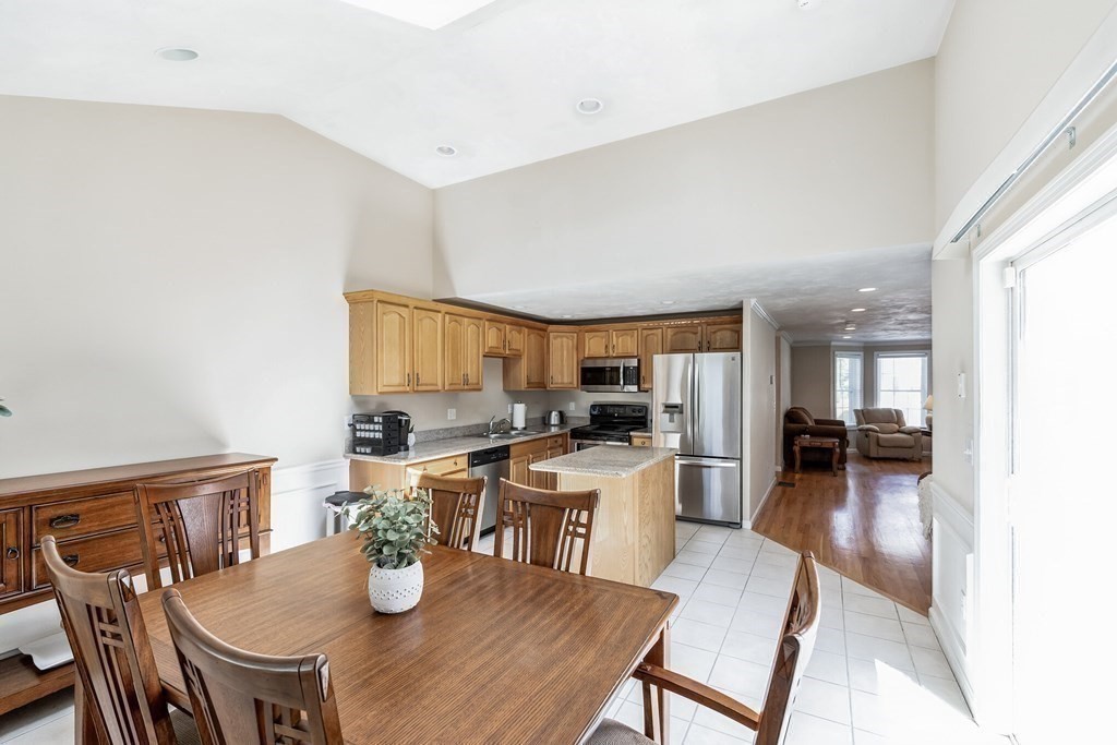 27 Honeysuckle Road Worcester, MA 01607 - Photo 9 of 30 a kitchen with a table chairs and wooden floor