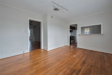 a view of empty room with wooden floor