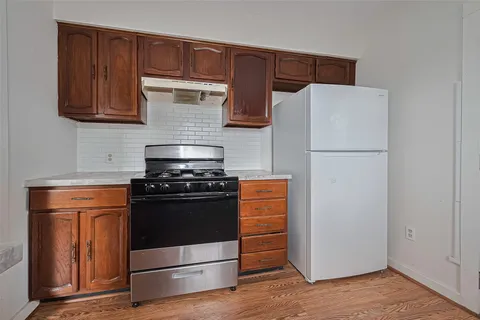 a kitchen with wooden cabinets and white appliances