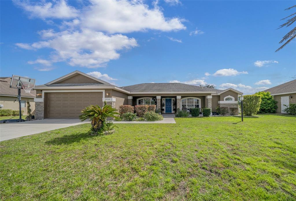 9934 Southwest 55th Ave Road Ocala, FL 34476 - Photo 1 of 1 a front view of a house with garden