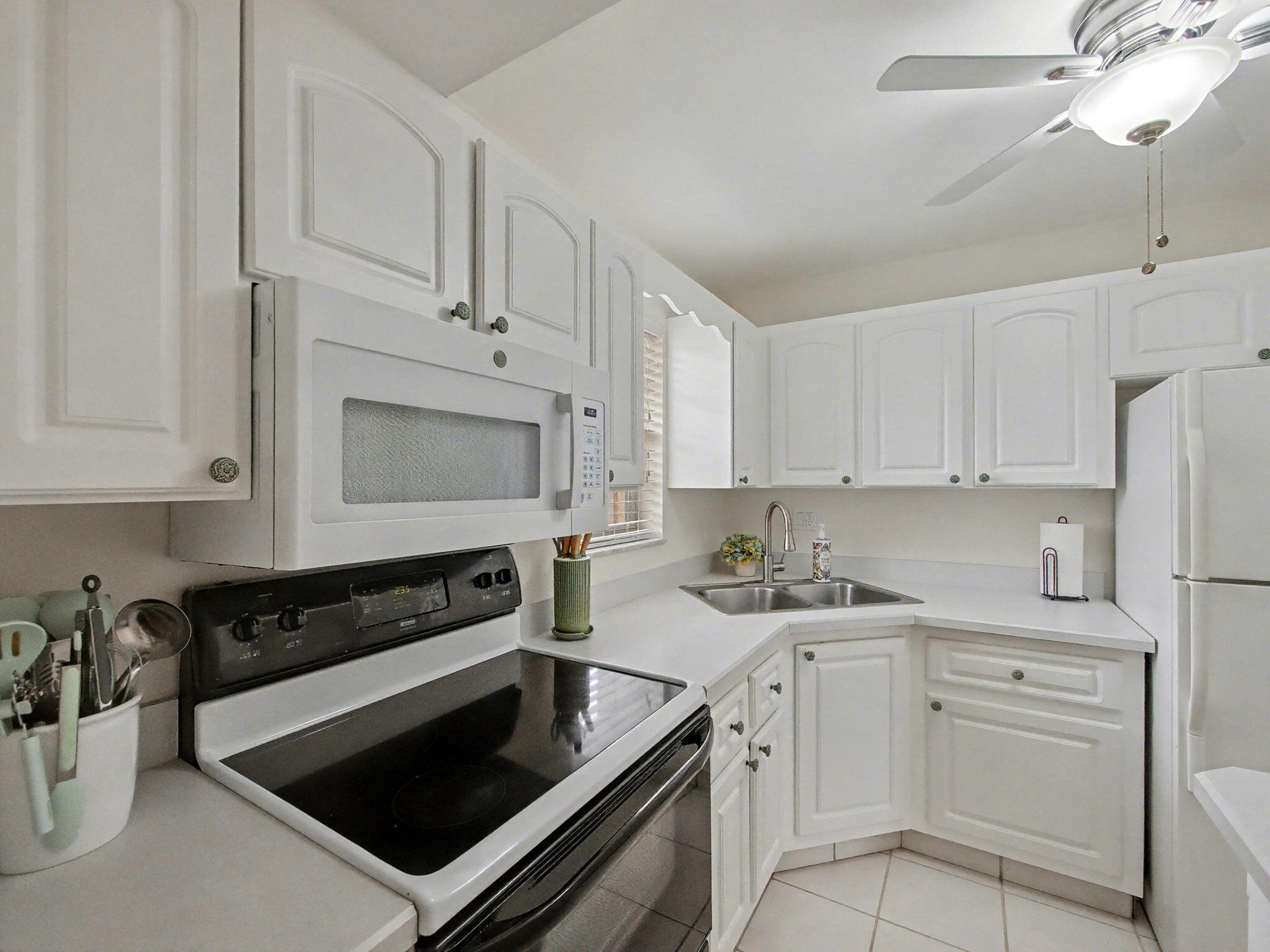 1967 Southwest Palm City Road, Unit 34C Stuart, FL 34994 - Photo 4 of 25 a kitchen with white cabinets and appliances