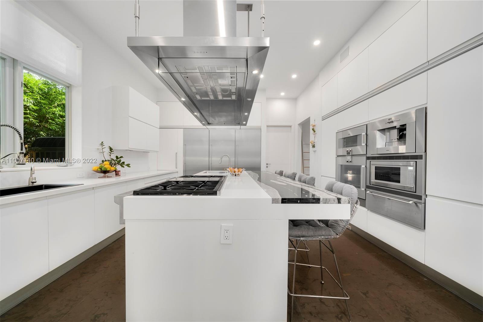 5030 Davis Road Miami, FL 33143 - Photo 6 of 29 a kitchen with a stove a sink and a refrigerator