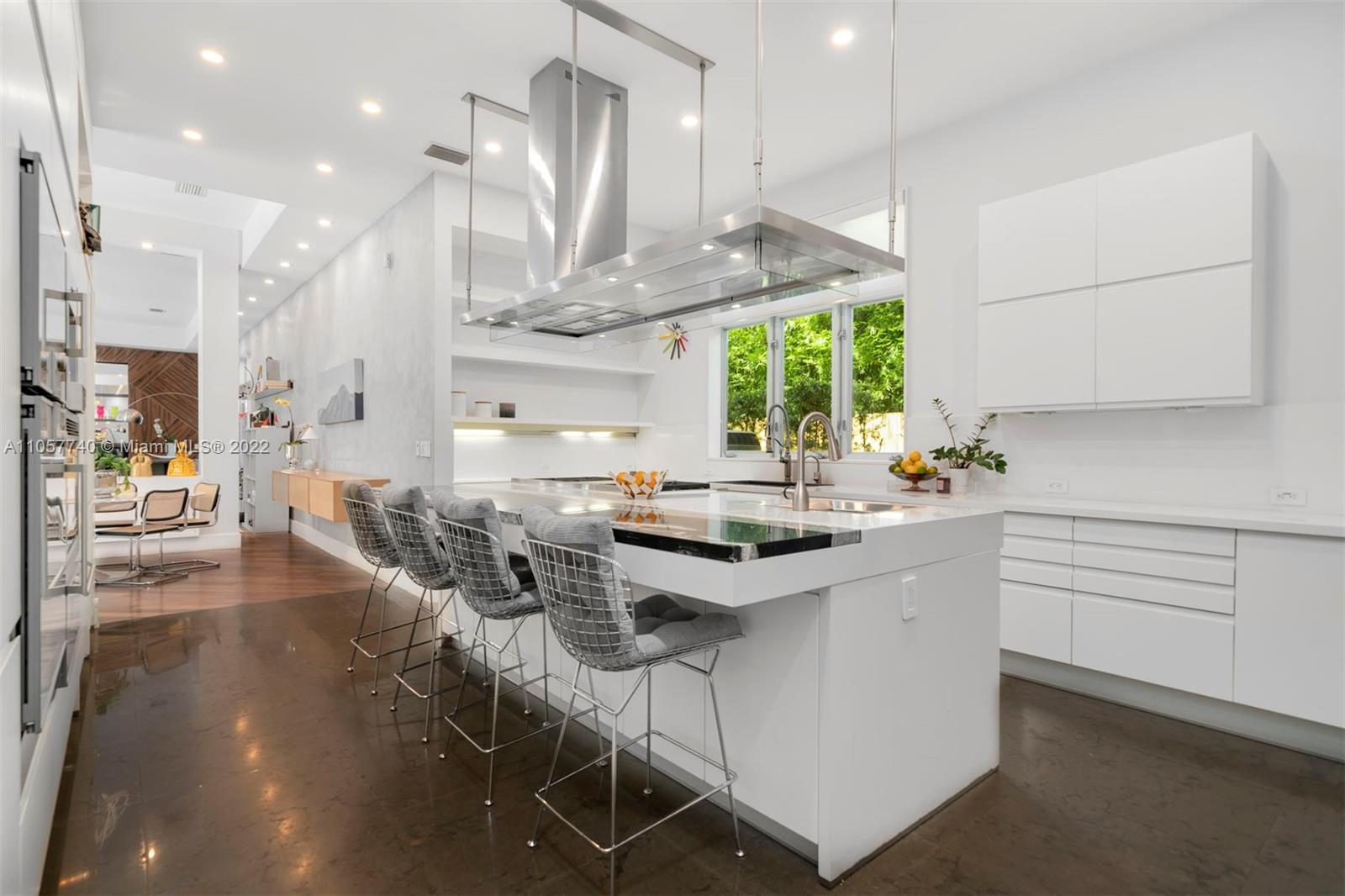 5030 Davis Road Miami, FL 33143 - Photo 7 of 29 a kitchen with stainless steel appliances kitchen island a large window a sink and cabinets
