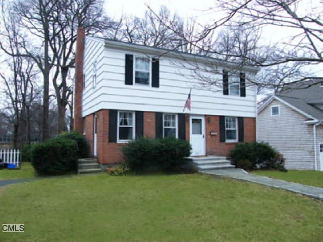 155 Highlawn Road Fairfield, CT 06824 - Photo 1 of 1 a front view of a house with a yard