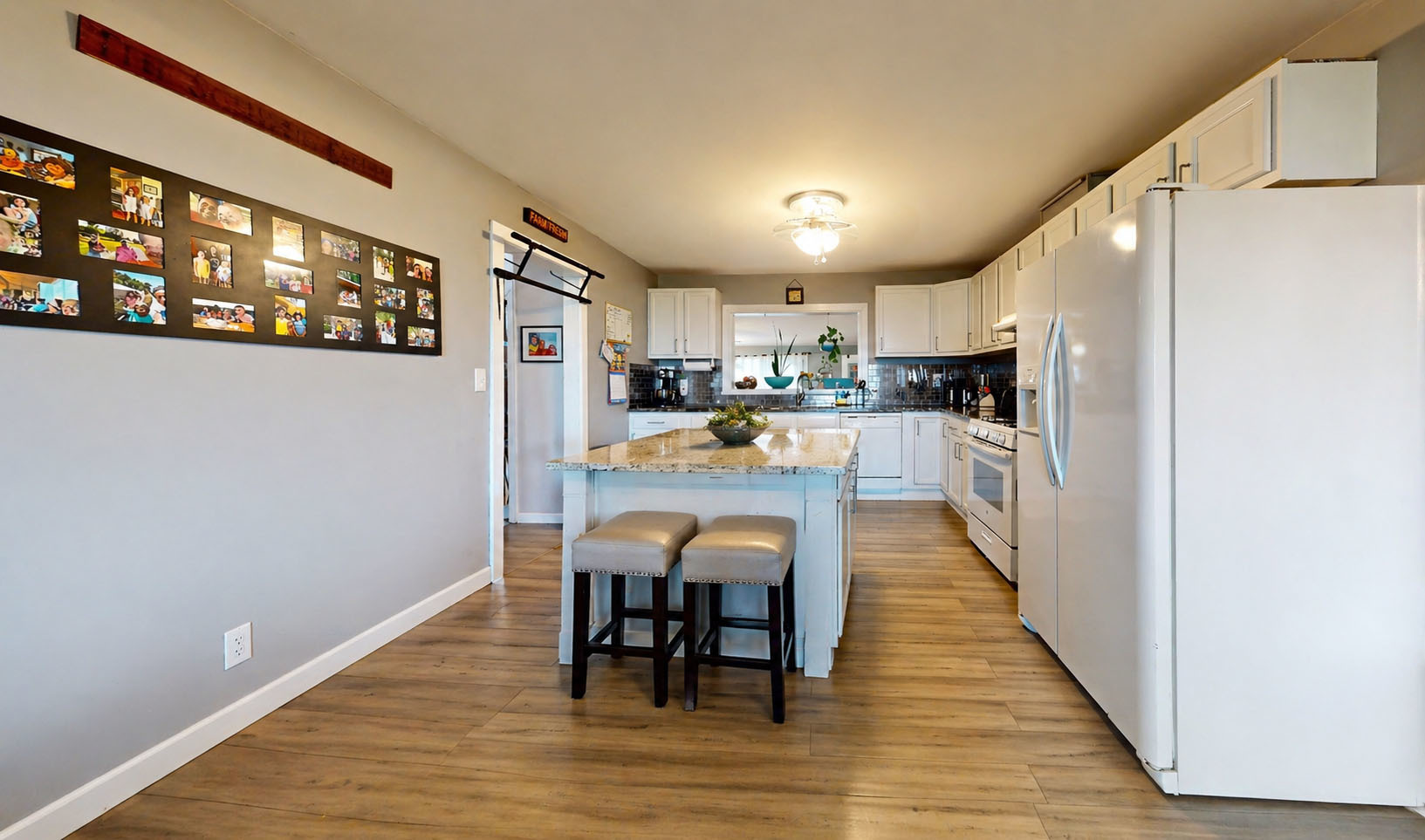 829 East Old Rte 47 Monticello, IL 61856 - Photo 3 of 16 a kitchen with stainless steel appliances granite countertop a refrigerator a microwave oven a sink with island and chairs