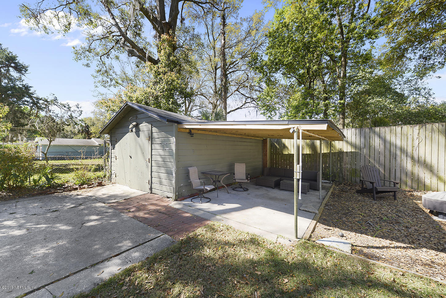 1704 Mayfair Road Jacksonville, FL 32207 - Photo 8 of 24 a backyard of a house with table and chairs