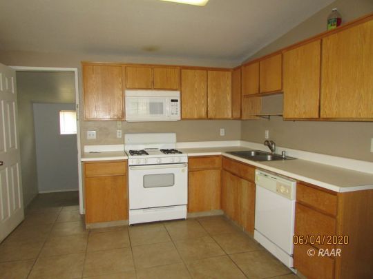 304 North Florence Street Ridgecrest, CA 93555 - Photo 11 of 21 a kitchen with a sink cabinets and window