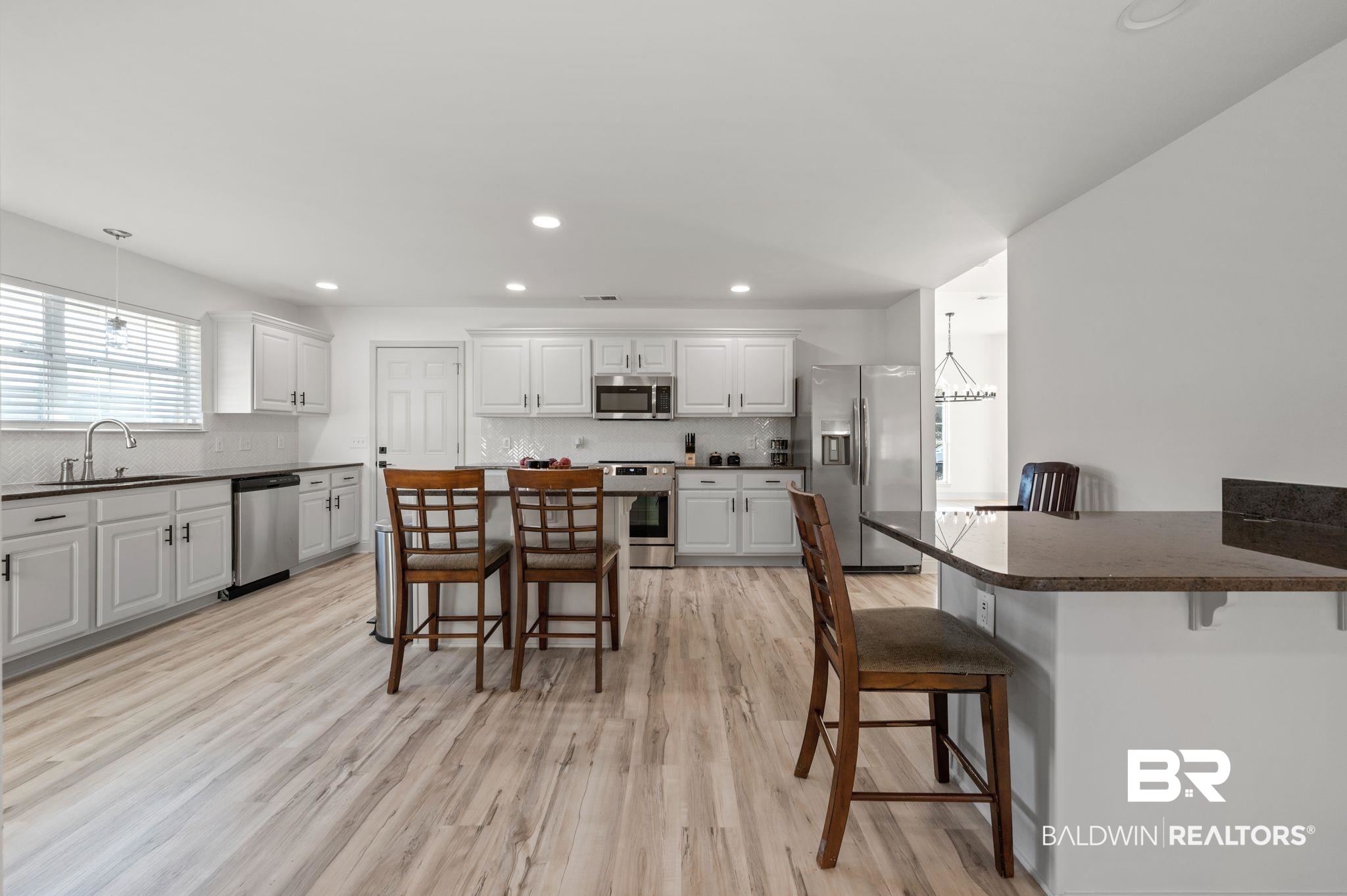 136 Destrehan Road Fairhope, AL 36532 - Photo 15 of 44 Kitchen with a kitchen breakfast bar, light hardwood / wood-style flooring, and stainless steel appliances