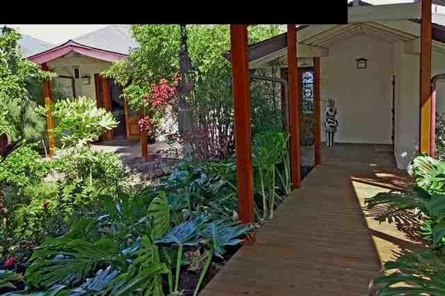 111 Door Of Faith Road Haiku, HI 96708 - Photo 20 of 23 a potted plant sitting in front of a house