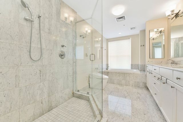 a bathroom with a granite countertop sink mirror and shower