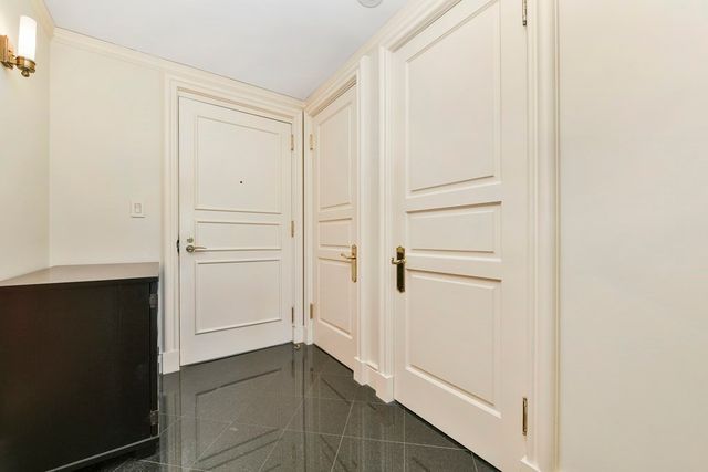 a living room with furniture fireplace and a large window