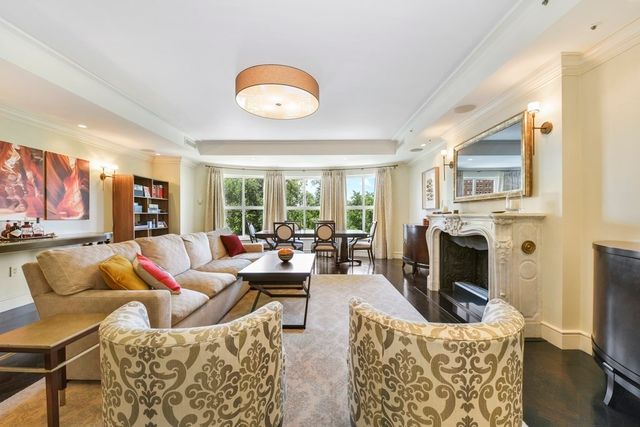 a living room with fireplace furniture and a flat screen tv