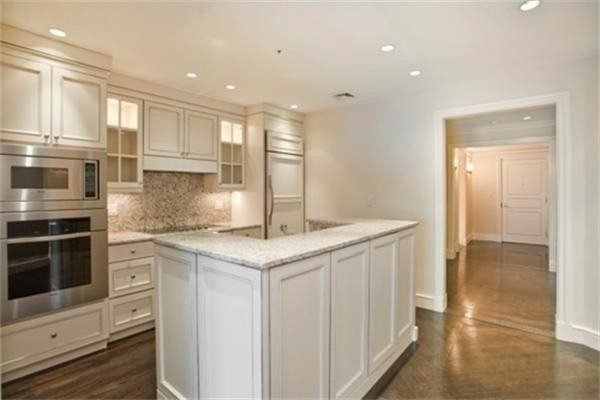 a kitchen with stainless steel appliances granite countertop a stove and a refrigerator