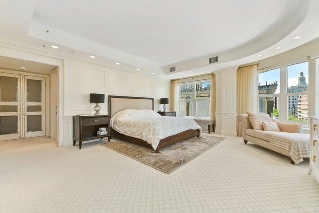 a bedroom with a bed and a couch