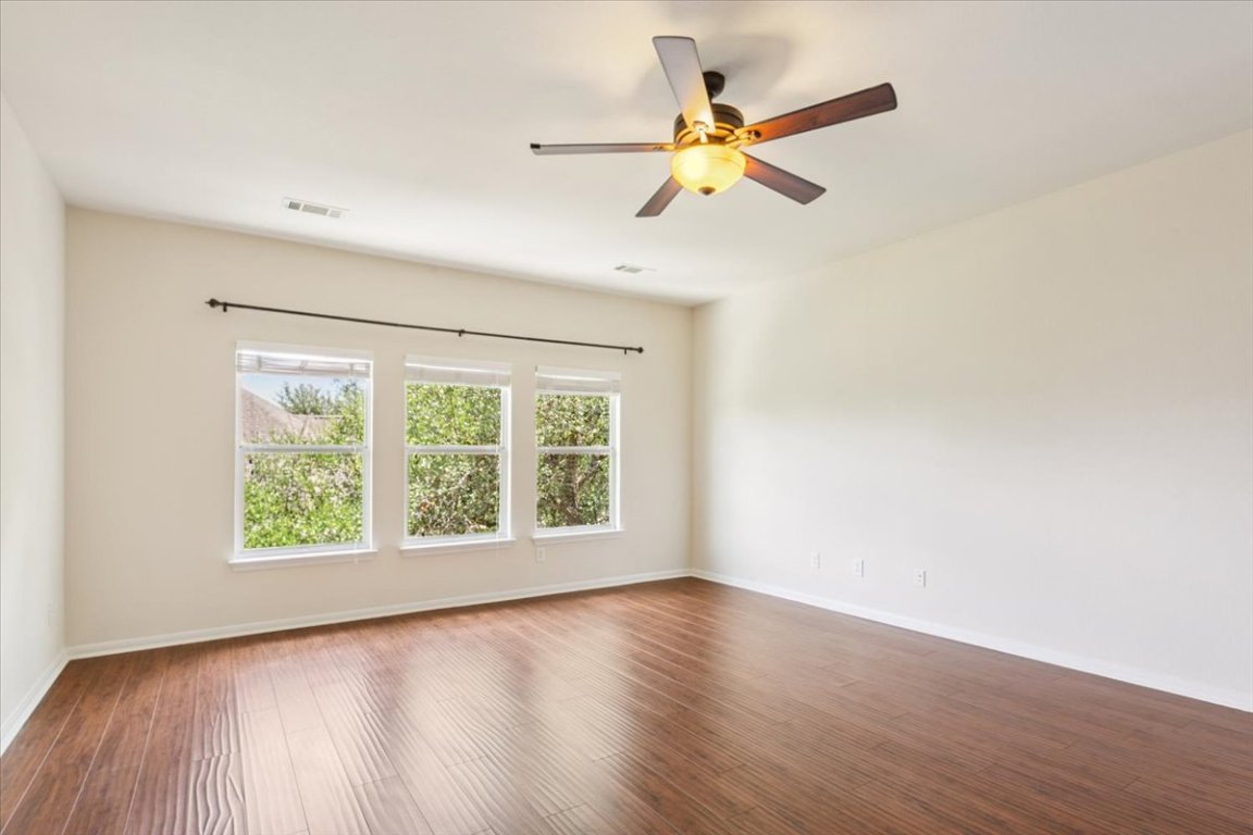 102 Country View Way Cedar Park, TX 78613 - Photo 17 of 38 Unfurnished room featuring wood finished floors and a ceiling fan