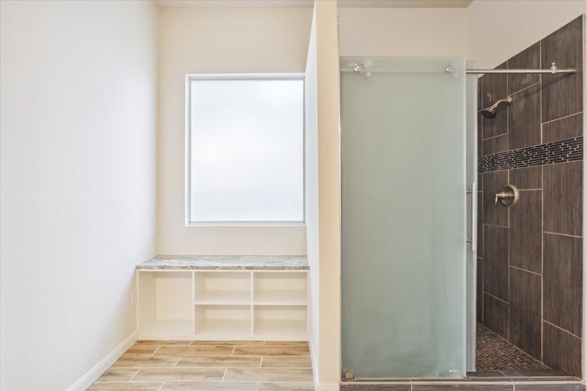 102 Country View Way Cedar Park, TX 78613 - Photo 19 of 38 Full bath featuring a shower stall and wood finished floors