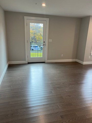 328 Bank, Unit 4 Harwich, MA 02645 - Photo 2 of 6 a view of an empty room with wooden floor and a window