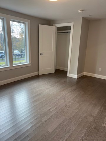328 Bank, Unit 4 Harwich, MA 02645 - Photo 4 of 6 an empty room with wooden floor and windows
