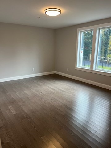 328 Bank, Unit 4 Harwich, MA 02645 - Photo 5 of 6 an empty room with wooden floor and windows
