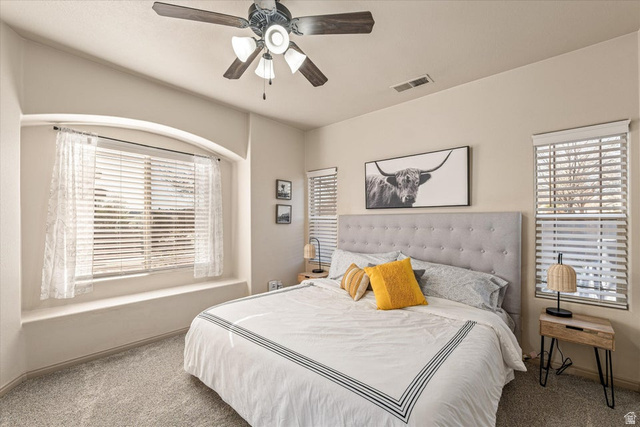 345 North 2450th Street East, Unit 152 St. George, UT 84790 - Photo 17 of 40 Bedroom featuring carpet flooring, ceiling fan, and multiple windows