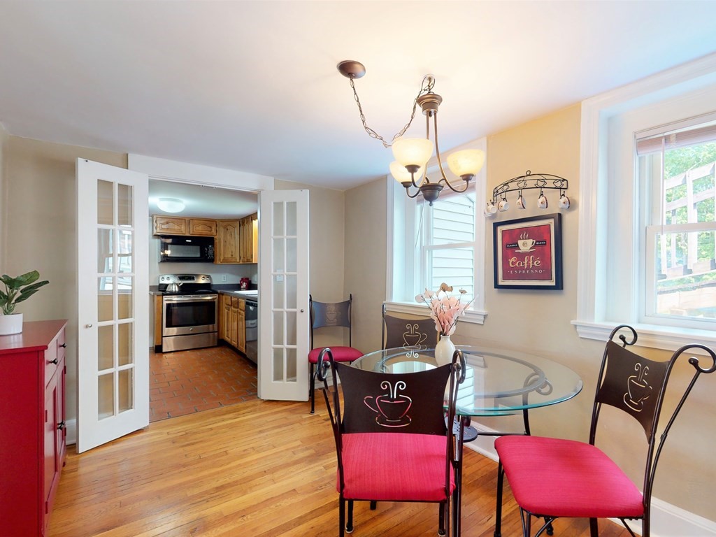 54 Carlin Road Waltham, MA 02451 - Photo 8 of 41 a view of a dining room with furniture a chandelier and wooden floor