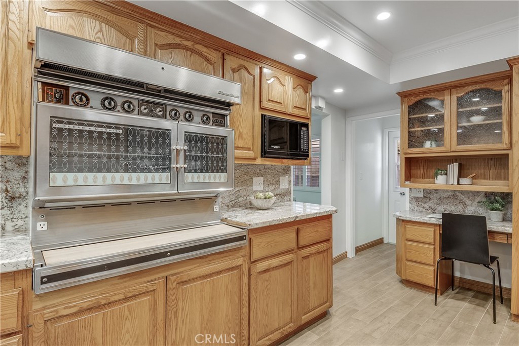 214 Angelo Walk Long Beach, CA 90803 - Photo 11 of 36 a kitchen with stainless steel appliances granite countertop a stove and a sink