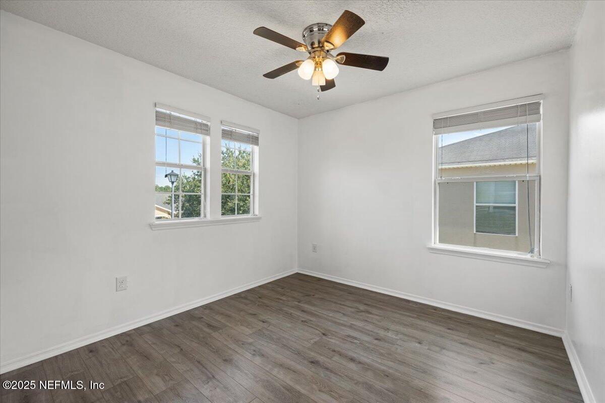 77347 Cobblestone Drive Yulee, FL 32097 - Photo 28 of 35 wooden floor in an empty room with a window