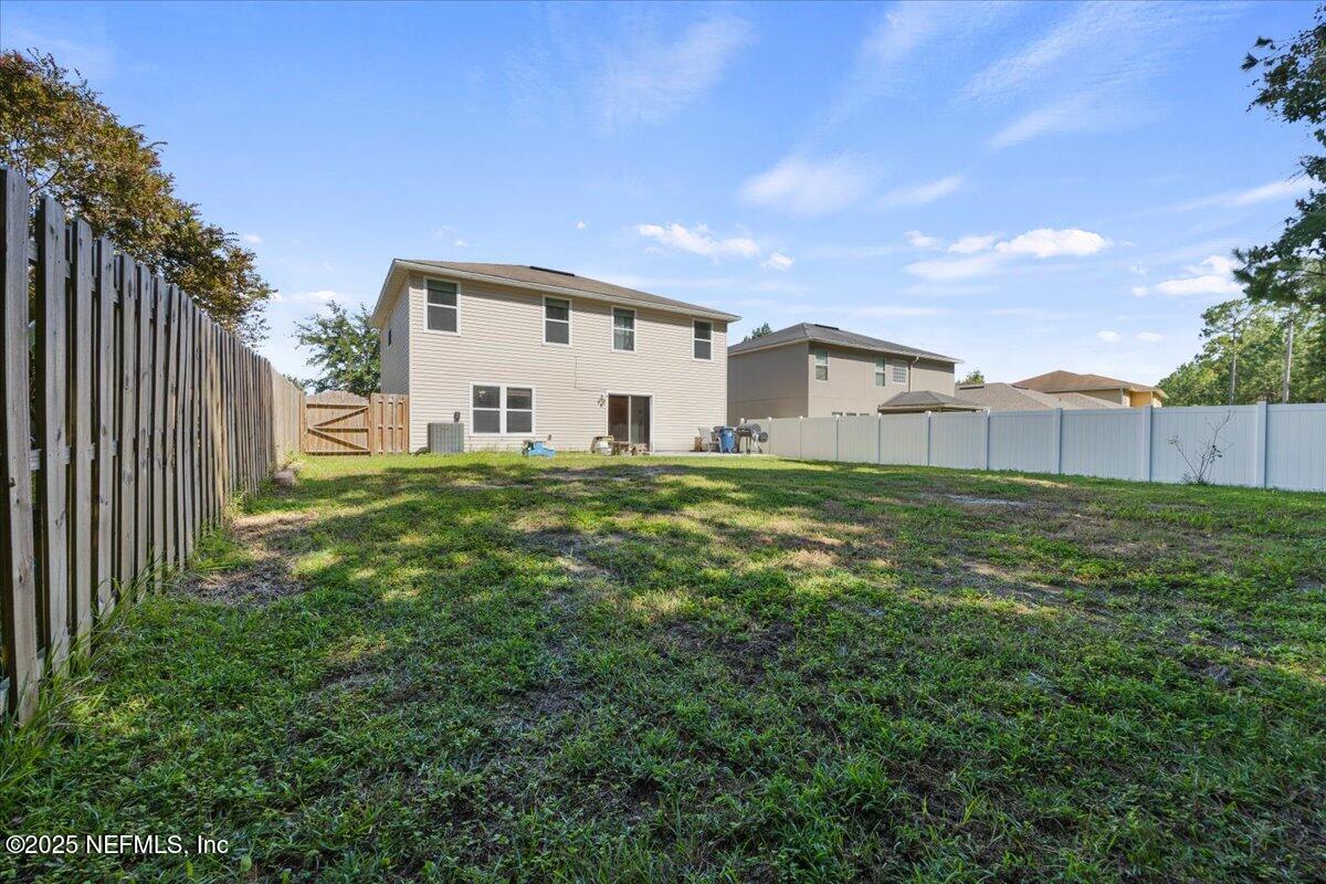 77347 Cobblestone Drive Yulee, FL 32097 - Photo 34 of 35 a house view with a garden space