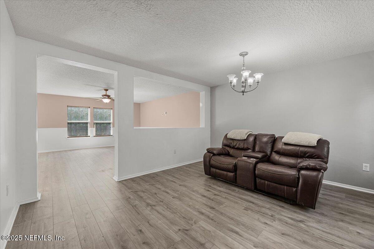 77347 Cobblestone Drive Yulee, FL 32097 - Photo 4 of 35 a living room with furniture and a chandelier