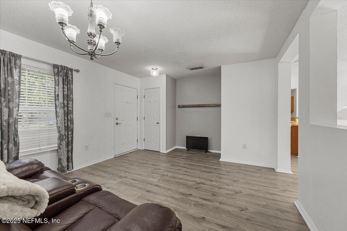 77347 Cobblestone Drive Yulee, FL 32097 - Photo 6 of 35 a room with a bed and a chandelier