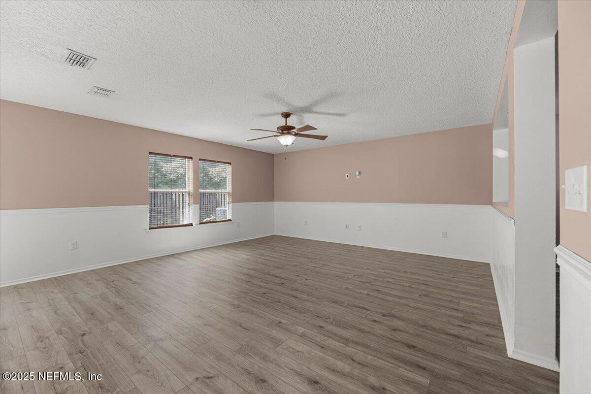 77347 Cobblestone Drive Yulee, FL 32097 - Photo 8 of 35 wooden floor in an empty room with a window