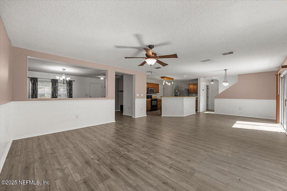 77347 Cobblestone Drive Yulee, FL 32097 - Photo 10 of 35 a view of a kitchen with a sink and a stove top oven