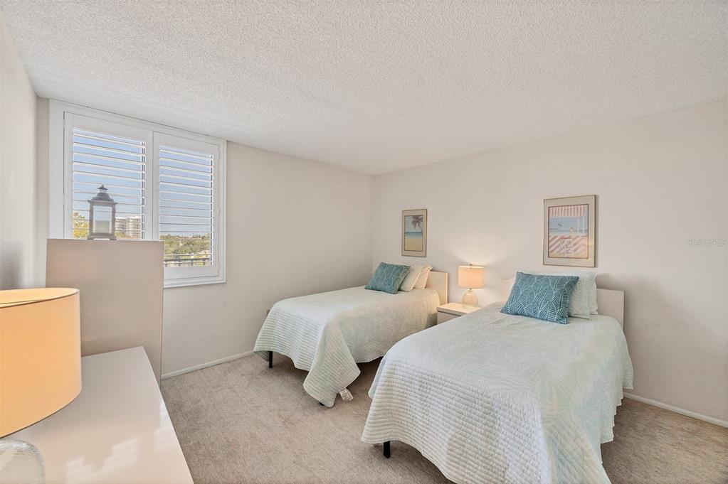 6285 Midnight Pass Road, Unit 403 Sarasota, FL 34242 - Photo 19 of 51 a bedroom with two beds and a window