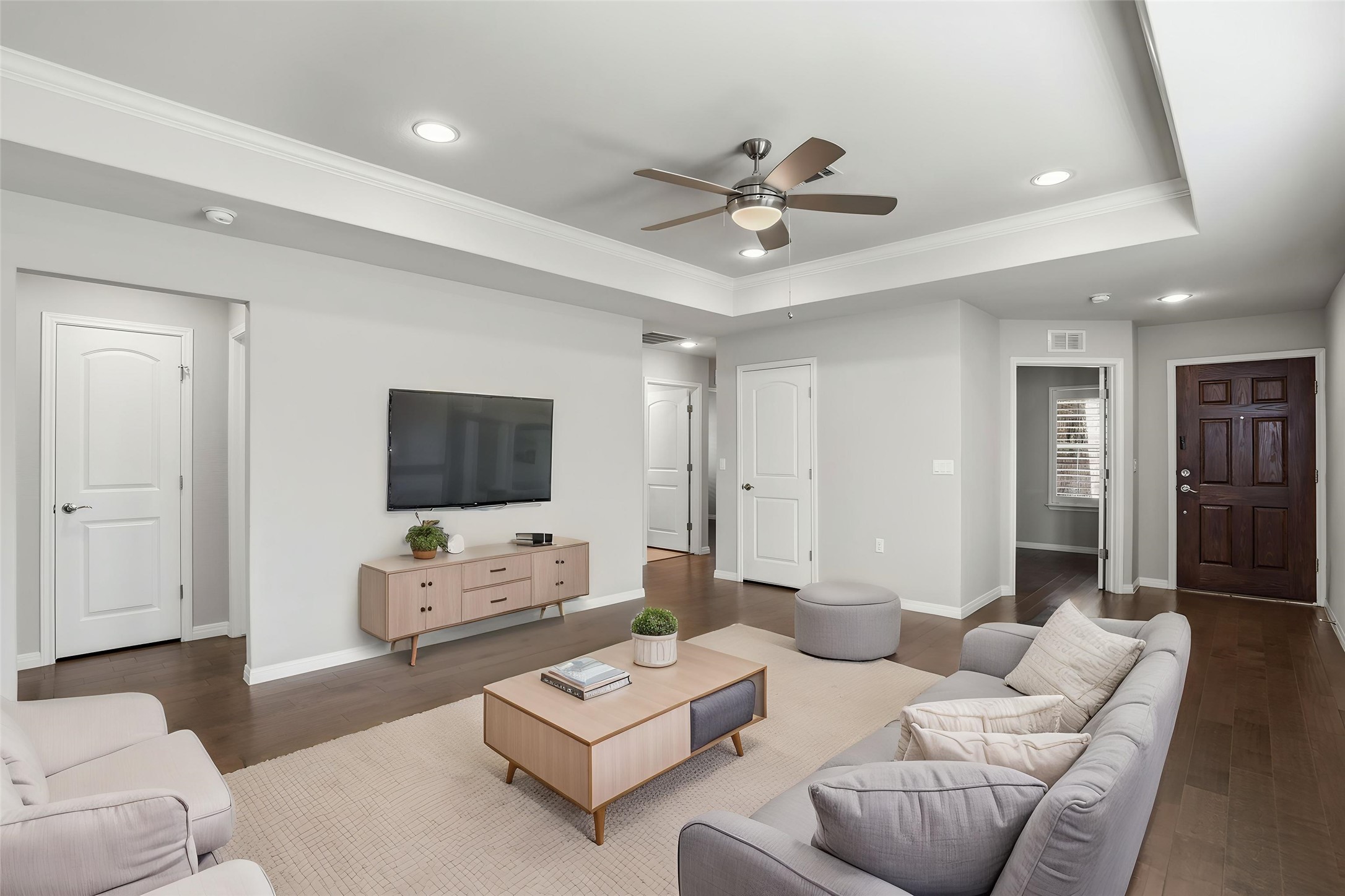 821 Hamilton Lane Georgetown, TX 78633 - Photo 3 of 38 Spacious living room featuring engineered wood floors, a tray ceiling with recessed lighting, and a ceiling fan (virtually staged)