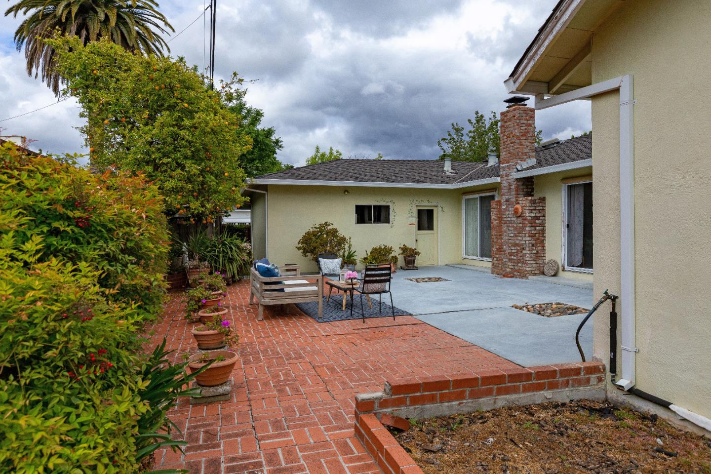 19030 Brookview Drive Saratoga, CA 95070 - Photo 21 of 22 a view of a patio with table and chairs and potted plants