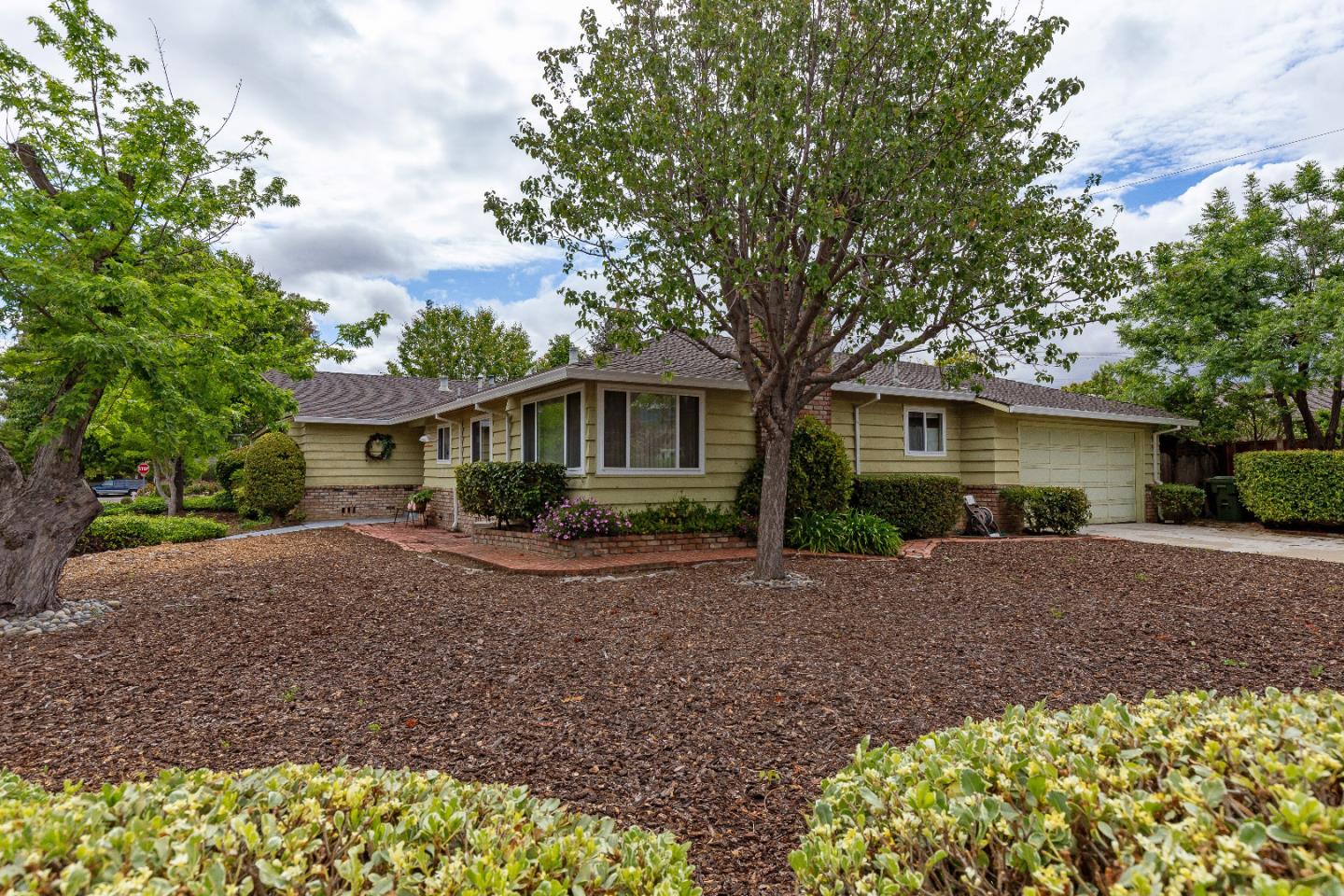 19030 Brookview Drive Saratoga, CA 95070 - Photo 3 of 22 a front view of a house with a garden