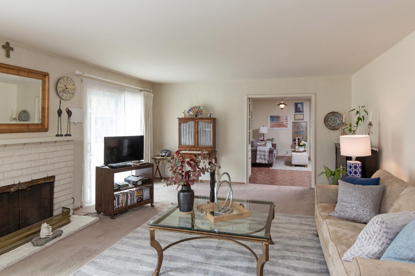 19030 Brookview Drive Saratoga, CA 95070 - Photo 8 of 22 a living room with furniture a fireplace and a flat screen tv
