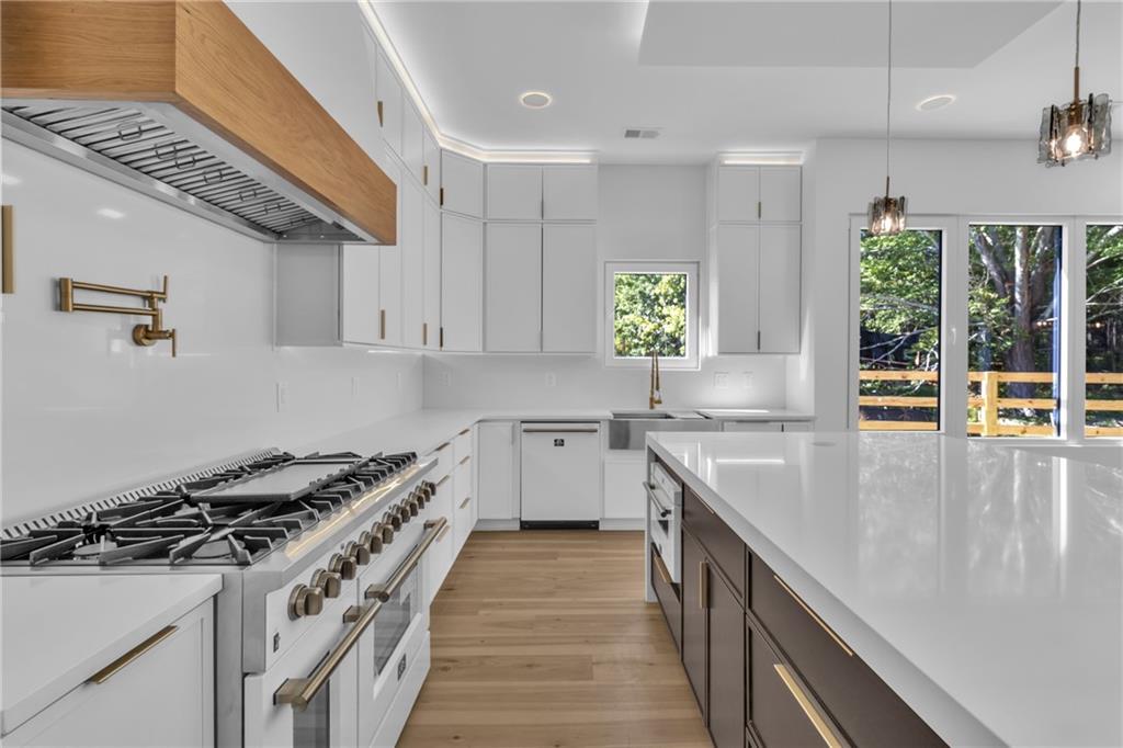1939 Sunny Hill Road Lawrenceville, GA 30043 - Photo 18 of 47 a kitchen with a stove sink and cabinets