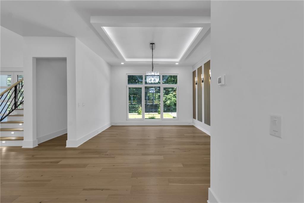 1939 Sunny Hill Road Lawrenceville, GA 30043 - Photo 20 of 47 a view of an empty room with wooden floor and a window