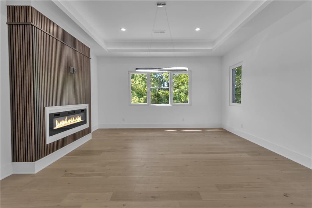1939 Sunny Hill Road Lawrenceville, GA 30043 - Photo 21 of 47 an empty room with windows and fireplace