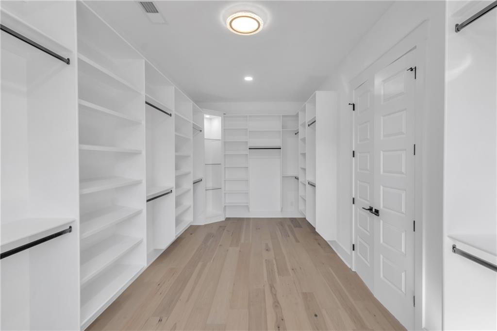 1939 Sunny Hill Road Lawrenceville, GA 30043 - Photo 30 of 47 a view of a hallway with wooden floor and closet