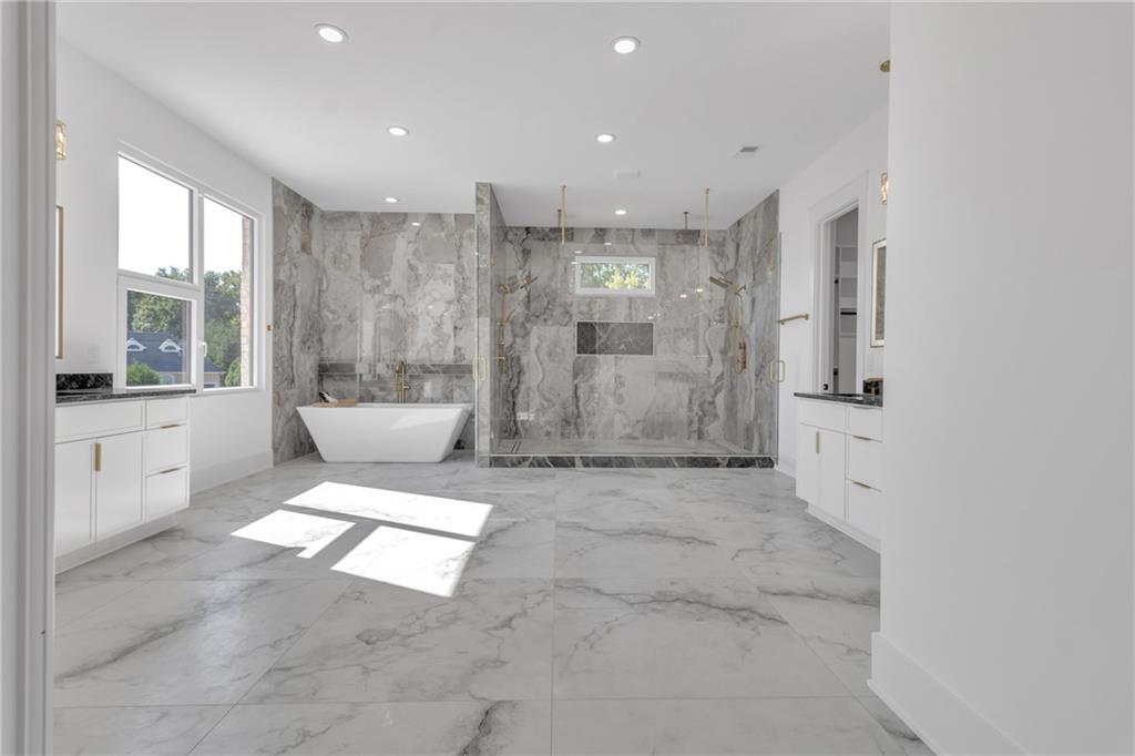 1939 Sunny Hill Road Lawrenceville, GA 30043 - Photo 31 of 47 a view of a bathroom with a bathtub and a sink
