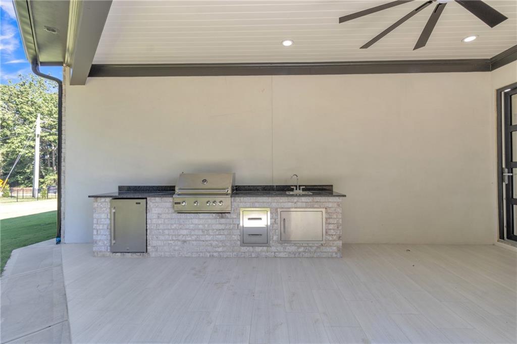 1939 Sunny Hill Road Lawrenceville, GA 30043 - Photo 37 of 47 a view of a kitchen with stove and cabinets