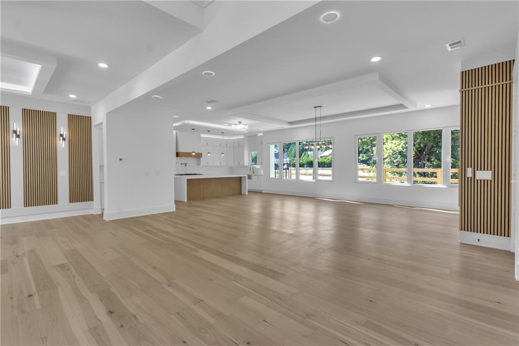 1939 Sunny Hill Road Lawrenceville, GA 30043 - Photo 6 of 47 an empty room with wooden floor and windows