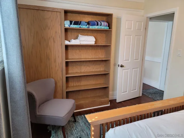 a bedroom with a bed and a night stand