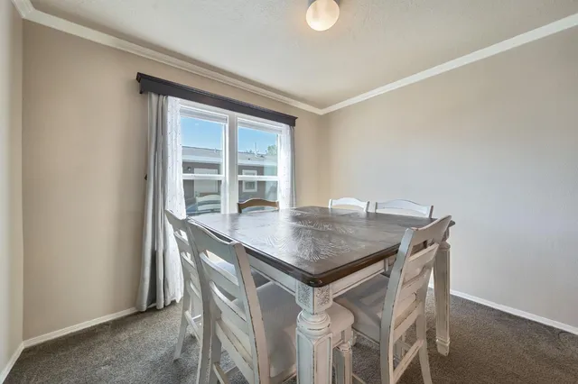 a dining room with a table and chairs