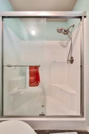 a bathroom with a bathtub and a shower