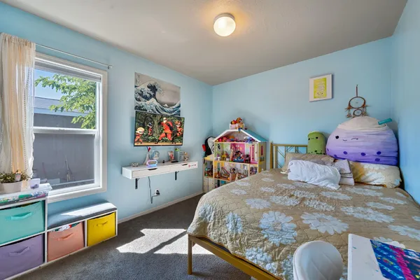 a bedroom with 2 bed and a dresser