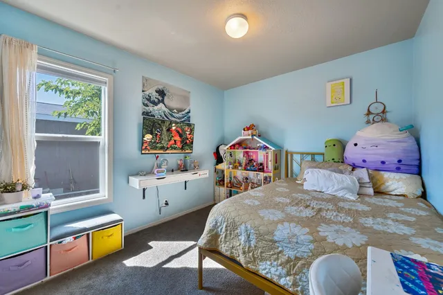 a bedroom with 2 bed and a dresser