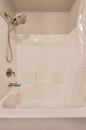 a bathroom with a bathtub and a shower